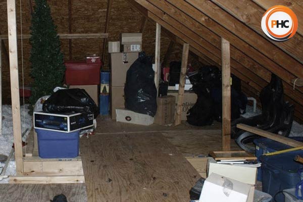 a loft with rubbish christmas decorations and boxes