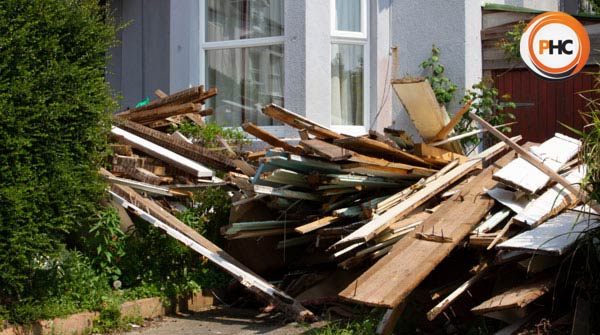 lots of rubbish in front garden of house