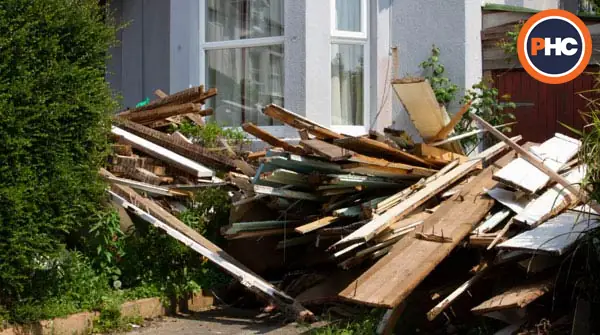 lots of rubbish in front garden of house